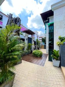a courtyard of a building with a wooden floor and plants at Yotaka Bangkok Hotel in Bang Kapi