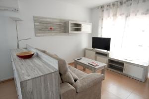 a living room with a couch and a table at EBRE-SET in Sant Jaume d'Enveja