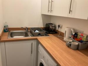 a kitchen with a sink and a counter top at 103 Nelson Street 1 st floor Right in Largs