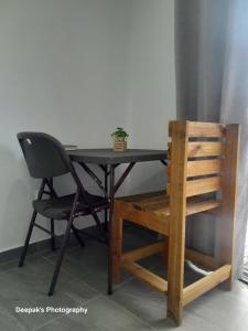 a black table with a chair and a plant on it at Peace Hut in Nadi