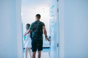 a man with a backpack walking into a hospital corridor at HD Acuario Lifestyle in Las Palmas de Gran Canaria