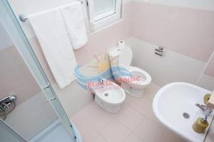 a bathroom with a toilet and a sink at APARTMANI LUX SEA in Utjeha