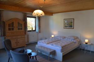 a bedroom with a bed and a chandelier at City-apart Kitzbühel Stadt in Kitzbühel