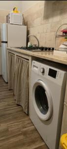 a washing machine in a kitchen with a counter at Casa Principe Taranto "Intero appartamento" in Taranto