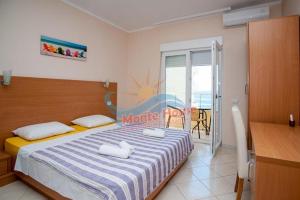 a bedroom with a bed with two towels on it at APARTMANI LUX SEA in Utjeha