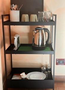 a shelf with a tea kettle and a plate on it at Mandra Chiusilla in Collesano