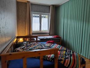 a bedroom with two bunk beds and a window at Hasthaushof in Breitscheid