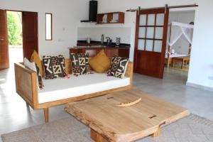 a living room with a couch and a wooden table at Kivuli Beach Resort Paje in Paje