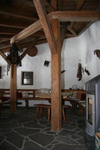 a living room with wooden beams and a table at Gasthaus Marie in Achenkirch