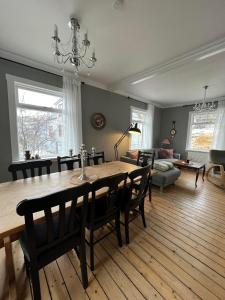 a dining room with a table and chairs and a living room at Charming Villa with mountain view in Siglufjörður