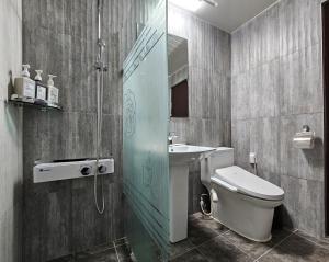 a bathroom with a toilet and a sink and a shower at HOTEL ViA in Ansan