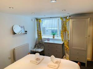a bedroom with two beds and a dresser and a window at Apartment near Harbourside & city centre in Bristol