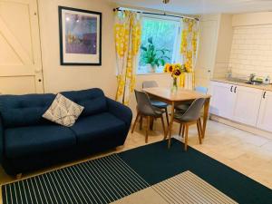 a living room with a blue couch and a table at Apartment near Harbourside & city centre in Bristol