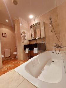 a large white bath tub in a bathroom at Hotel Spa Milagros Golf in Mogro