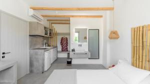 a white kitchen with a sink and a bathroom at Agia Kyriaki Studios in Agia Kiriaki Beach