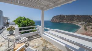 a balcony with chairs and a view of the ocean at Agia Kyriaki Studios in Agia Kiriaki Beach