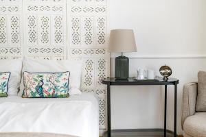 A bed or beds in a room at Beletage-Boutique Hotel