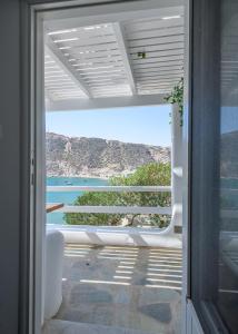 a room with a view of the ocean through a door at Agia Kyriaki Studios in Agia Kiriaki Beach
