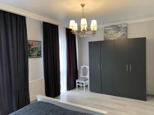 a bedroom with a large black cabinet and a chair at Anna’s dim in Uzhhorod