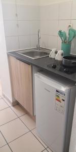 a kitchen with a sink and a refrigerator at Studio équipé Clim TV Wifi in Saint-Denis