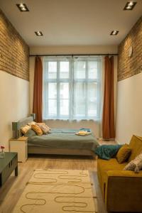 a bedroom with a bed and a large window at Downtown apartment 2 minutes from Opera House in Budapest