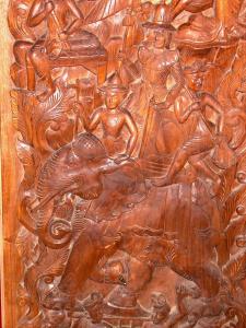 a wooden door with a carving of a man riding an elephant at Prince Edouard Apartments & Resort SHA extra plus in Patong Beach