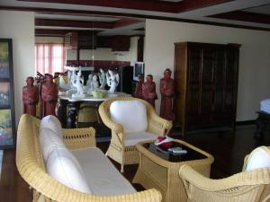 sala de estar con sillas de mimbre y mesa en Prince Edouard Apartments & Resort SHA extra plus en Patong Beach