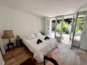 a bedroom with a bed with two black cats on it at Superbe villa avec piscine à 10 min du centre in La Rochelle +45 photos