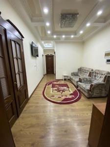 a living room with a couch and a rug at Narke Hostel in Bishkek