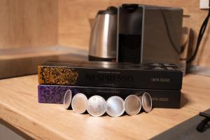 two boxes sitting on a counter next to a coffee maker at Urban Elegance by Eagles' Bridge in Sofia +17 photos