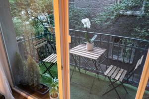 a balcony with a table and a flower on it at Urban Elegance by Eagles' Bridge in Sofia