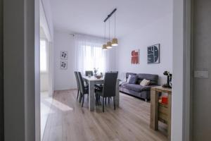 a dining room and living room with a table and chairs at SBS Room Rental in Bergamo +10 photos