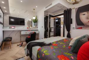 a bedroom with a bed with a colorful blanket at Beach Apartment 'Hedonist' in Makarska