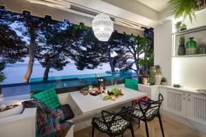 a dining room with a view of the ocean at Beach Apartment 'Hedonist' in Makarska