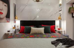 a bedroom with a large bed with red and green pillows at Beach Apartment 'Hedonist' in Makarska