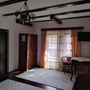 a living room with a window and a table at Zori de zi in Bran