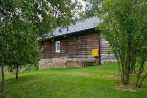 a log cabin with a window on the side of it at Morowo chałupa in Czchów
