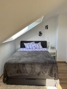 a bedroom with a bed in a attic at Ferienwohnung in Donaueschingen