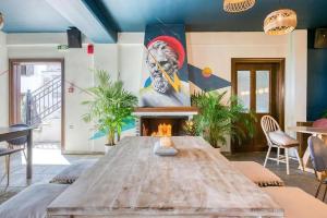 a living room with a wooden table and a painting at Makrinitsa Village in Makrinitsa