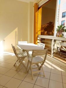 a white table and two chairs on a balcony at Stay in the heart of Agadir in Agadir