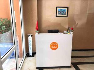 a white counter with a sign on it next to a door at Stay in the heart of Agadir in Agadir