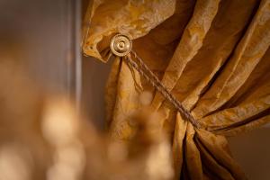 a close up of a curtain with a rope at San Giorgio Rooms in Genova