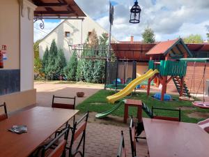 una zona de juegos con un parque infantil con tobogán en Gyulai Meseház Apartman, en Gyula