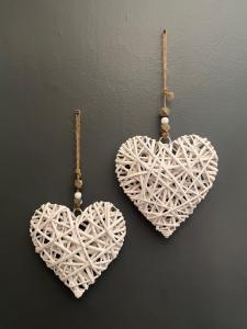 two white heart ornaments hanging on a wall at Marion Lodge in Johannesburg