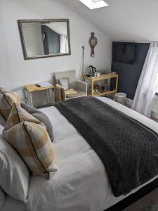 a bedroom with a large bed and a mirror at The Bridges B&B in Broomhill