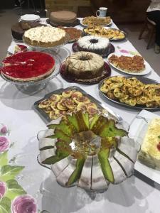 a table with many different types of cakes and pies at Vitória Torres Hotel in Torres