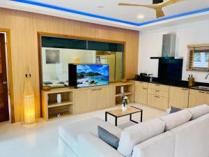 a living room with a white couch and a flat screen tv at Yuka residence in Koh Samui 