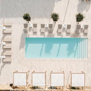 a swimming pool with chairs and a swimming pool at Masseria Corsano in Nardò