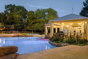 a swimming pool in front of a building at Sheraton Arlington Hotel in Arlington