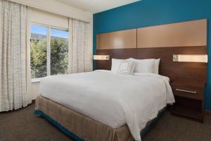 a large bed in a room with a large window at Residence Inn by Marriott Shreveport-Bossier City/Downtown in Bossier City